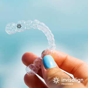 Hand holding invisalign braces