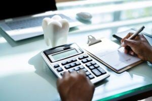 Hand of person using calculator