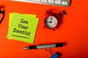 Clock with note reading 'See Your Dentist'
