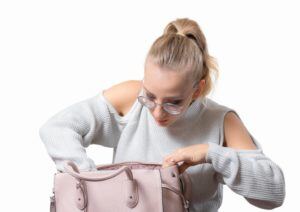 Woman searching in handbag