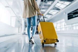 Person pulling rolling suitcase