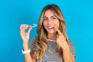 Young woman holding invisalign